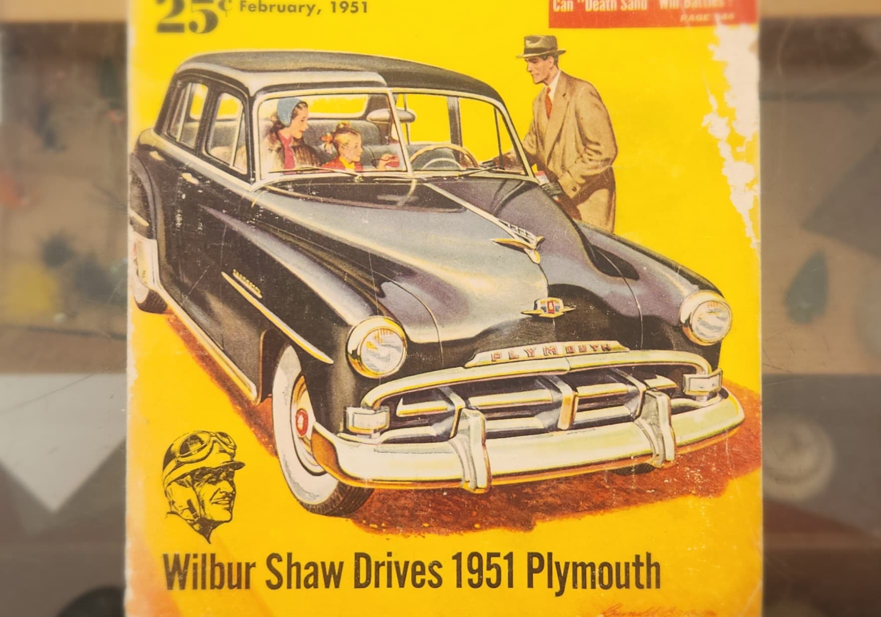 A vintage magazine cover featuring a 1951 Plymouth car with a driver and passengers. A vintage magazine cover featuring a 1951 Plymouth car with a driver and passengers.